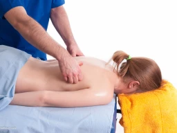 Massage therapist administering to a client. Chasing fingers technique applied on back.