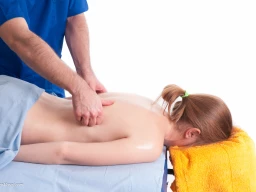 Massage therapist administering to a client. Chasing fingers technique applied on back.