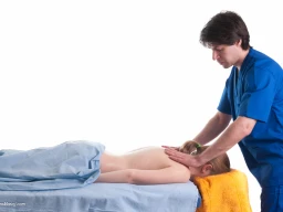 Massage therapist administering to a client. Massage techniques applied on trapezius.
