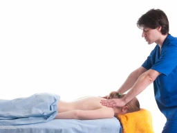 Massage therapist administering to a client. Massage techniques applied on trapezius.
